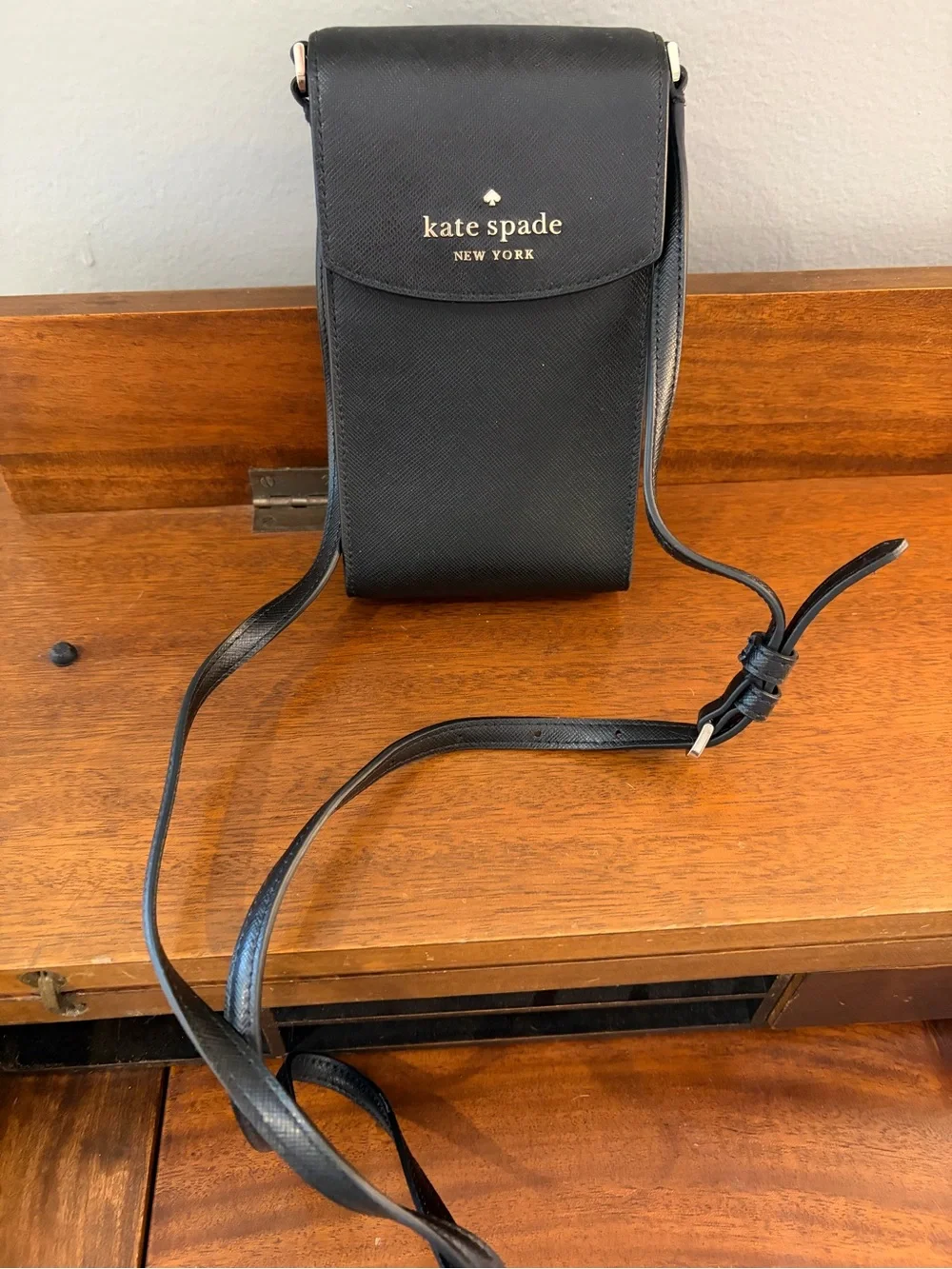 kate spade black saffiano leather phone pouch with gold logo